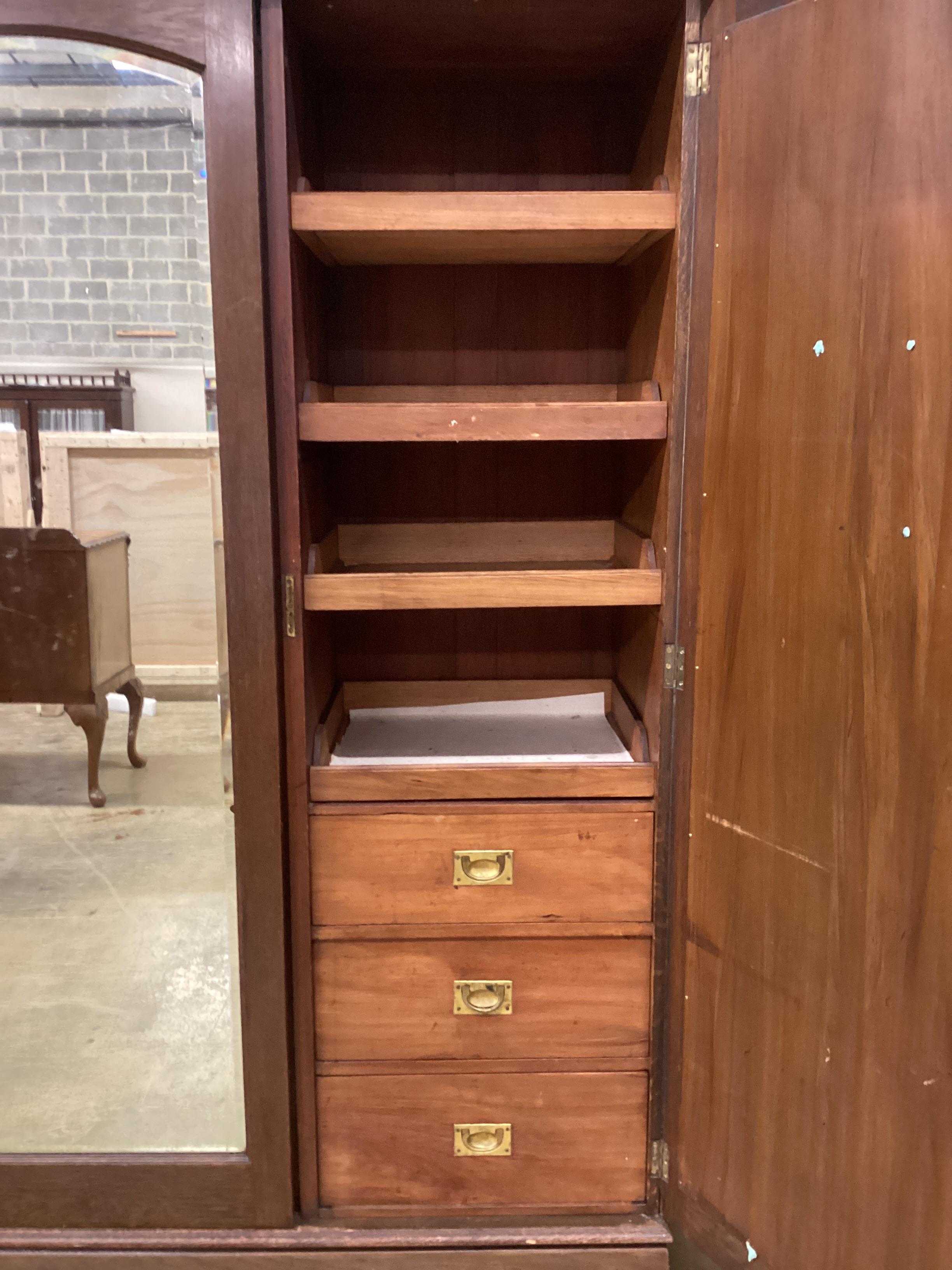 A late 19th century French Art Nouveau carved oak compactum wardrobe, width 205cm, depth 64cm, height 218cm